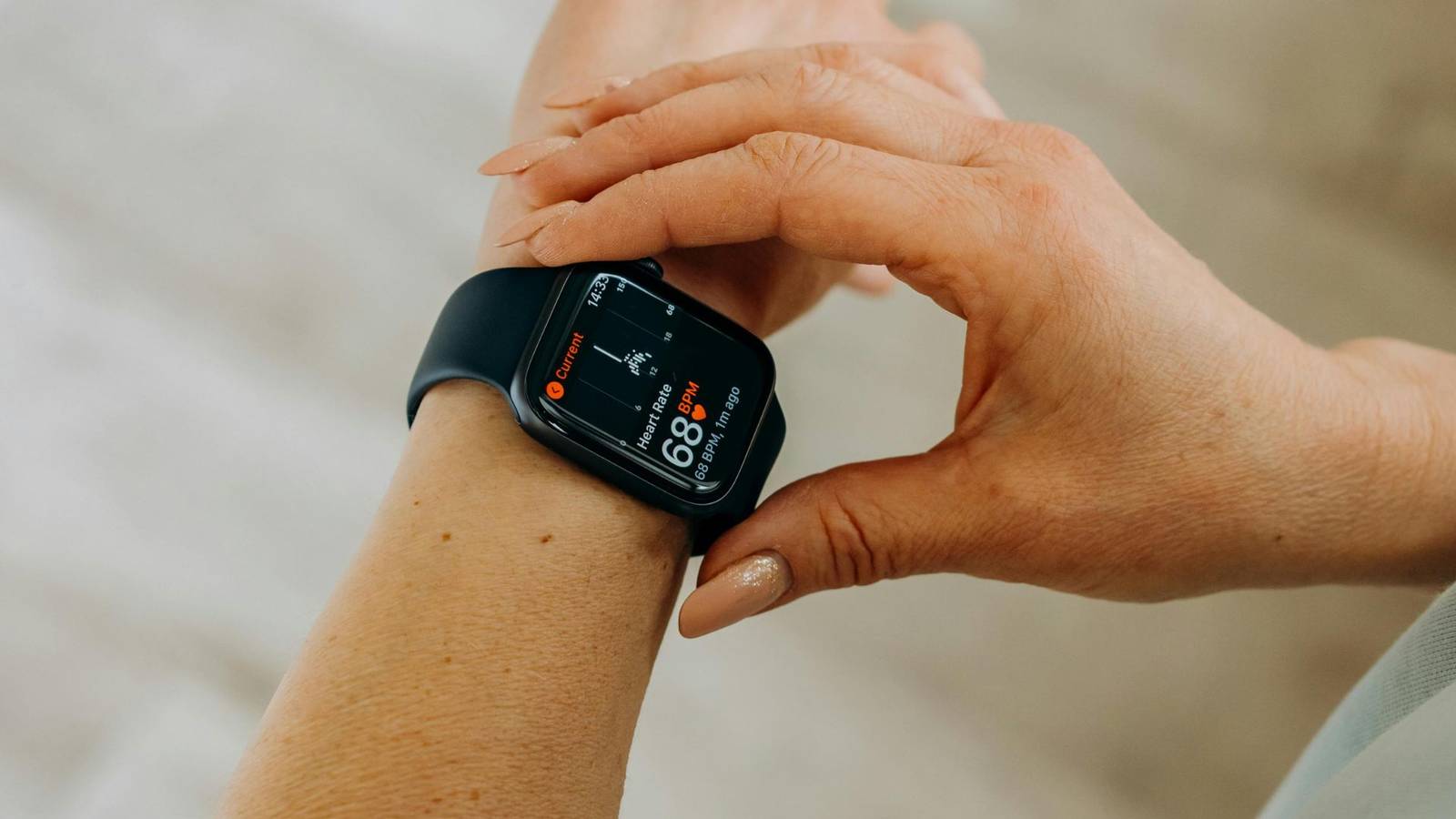 Person Looking at Her Black Smartwatch to control her hunger on creatine intake.